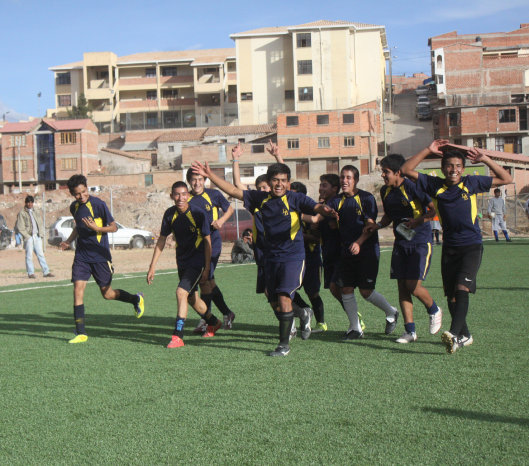 Los integrantes del equipo de ftbol de Don Bosco celebran dando la vuelta olmpica.