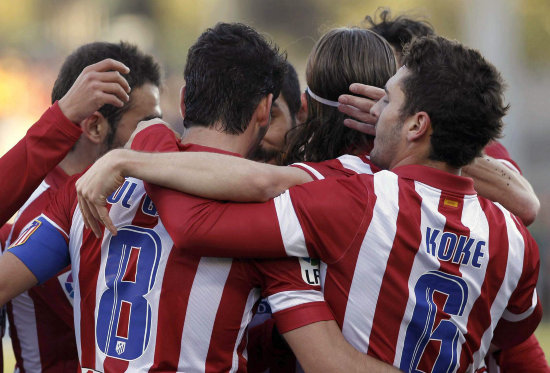 Los jugadores del Atltico de Madrid celebran la goleada; abajo, el Real Madrid no pas del empate.