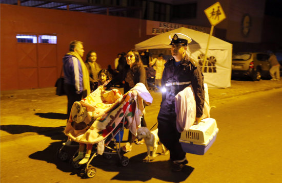 PRECAUCIN. Una familia en Iquique buscaba ponerse a buen recaudo anoche, tras declararse la alarma de evacuacin.