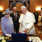 ENCUENTRO. Francisco recibe un regalo de manos de la reina Isabel II de Inglaterra.
