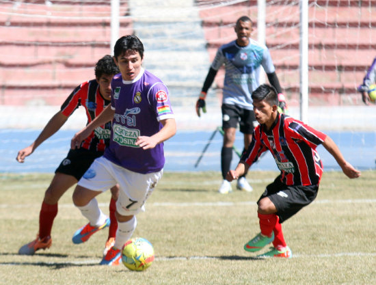 El volante Edgar Escalante (c) protege el baln ante la marca de dos jugadores de Nacional Potos.