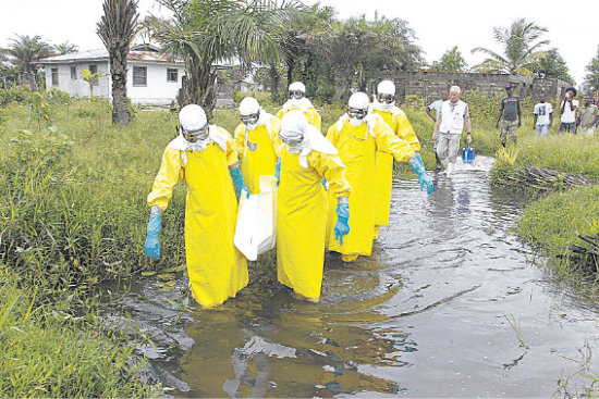 BROTE. Personal sanitario recorre un arroyo en Liberia, el pas ms afectado por la enfermedad.