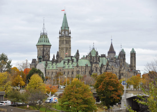 DUELO. Banderas a media asta ondean en la sede del Parlamento canadiense, en Ottawa, donde el mircoles se produjo el ataque armado.