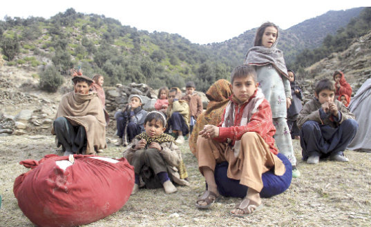 CONFLICTO. Nios afganos huyen con sus familias de la guerra en una regin montaosa de Afganistn, donde los talibanes son una amenaza.