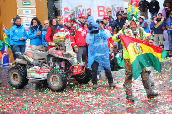 El piloto chuquisaqueo Wlter Nosiglia (d) celebra con la bandera de Bolivia su llegada a la rampa de Uyuni, luego de concluir su participacin en la sptima etapa del Rally Dakar.